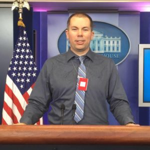 Josh Zytkiewicz poses for a photo in the White House Press Briefing Room. Photo Credit: Josh Zytkiewicz