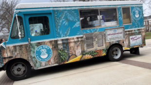 A blue Playa Bowls food truck